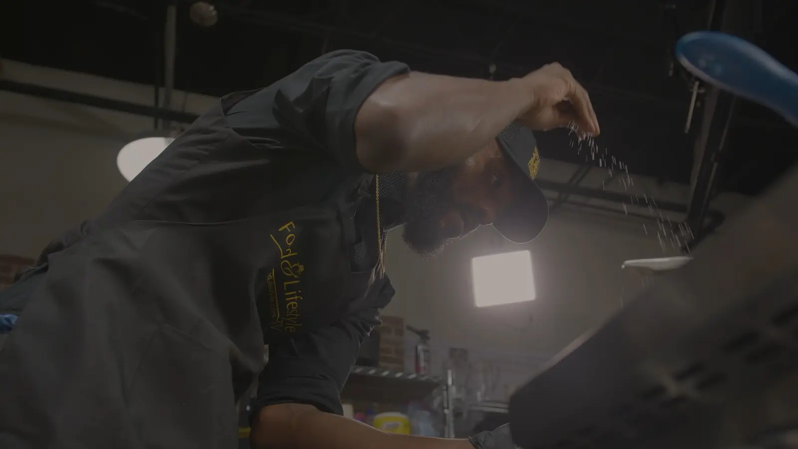 Chef seasoning food in the Food & Lifestyle studio kitchen